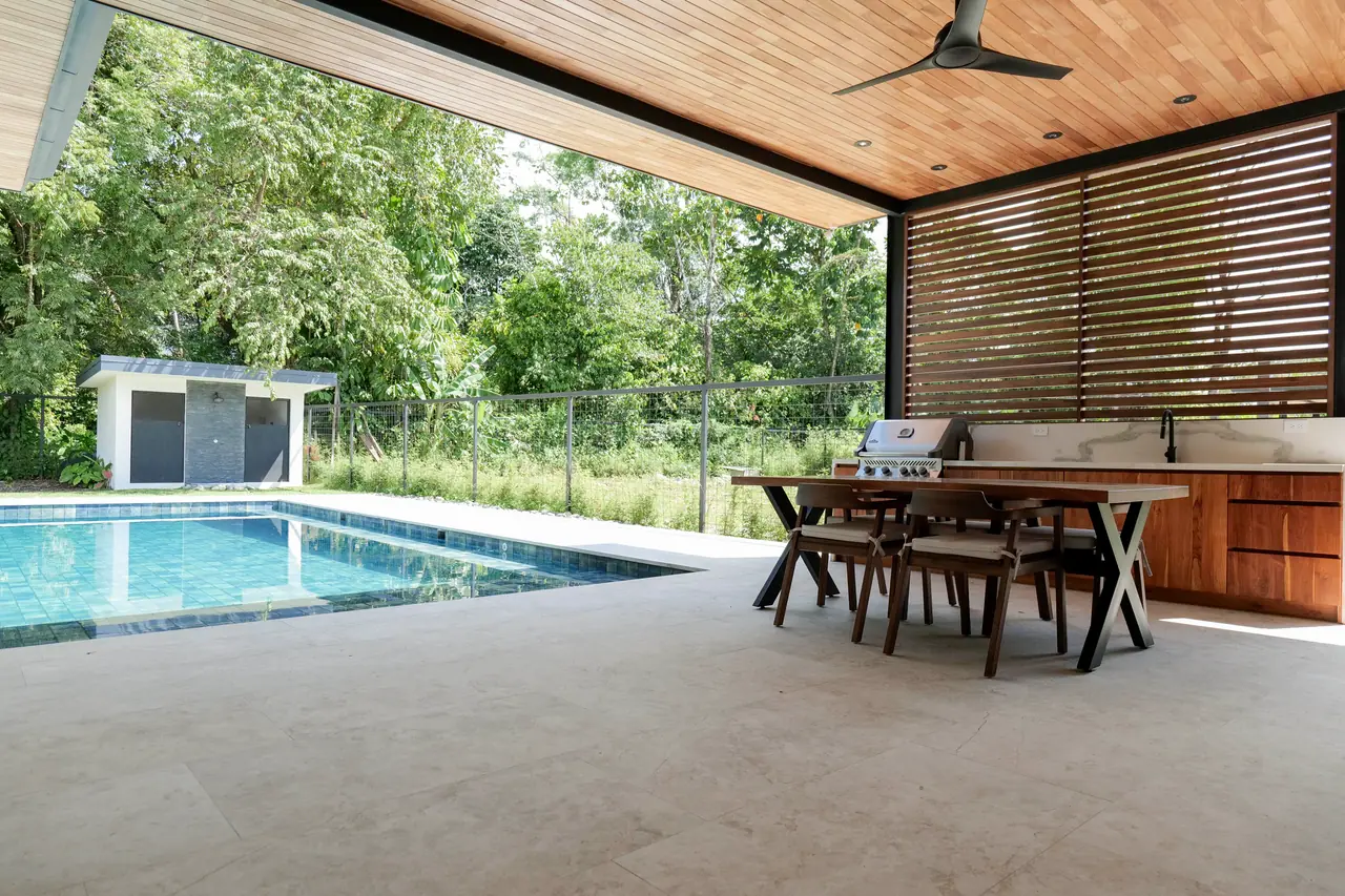 Pool and covered terrace from the shaded outdoor dining area