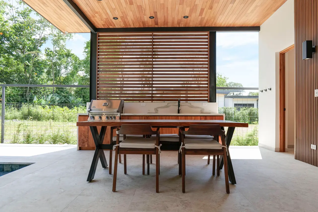 Outdoor dining under the hardwood-lined terrace ceiling
