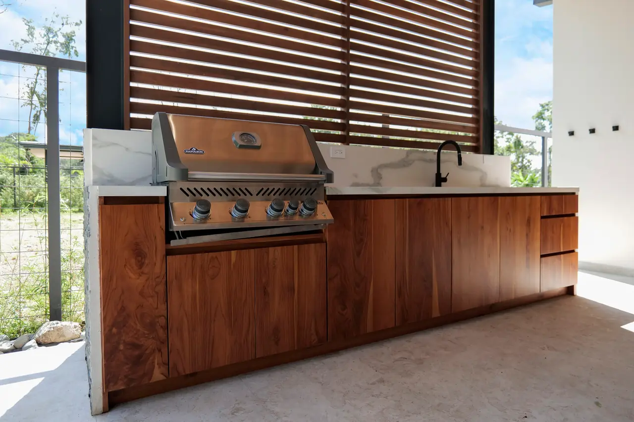 Built-in outdoor kitchen with gas grill and stone counter