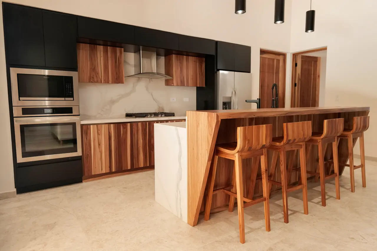 Kitchen island in solid hardwood with stone waterfall ends