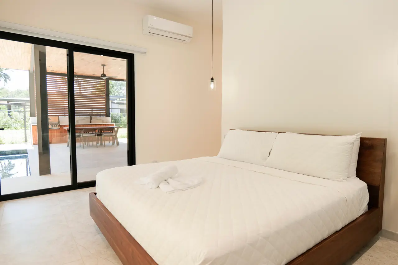 Primary bedroom opening onto the terrace through aluminium sliders