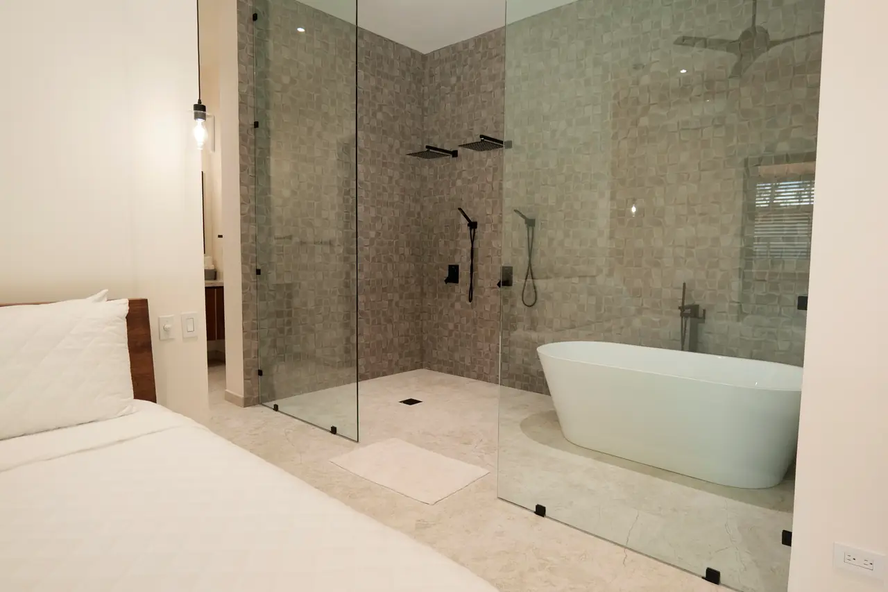 Ensuite — walk-in shower and freestanding tub in tiled stone