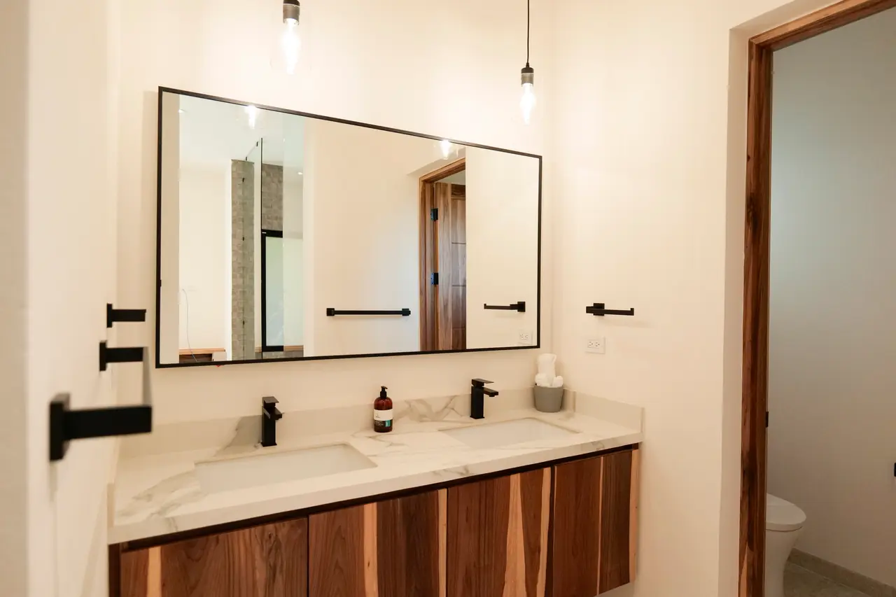Double vanity in stone with custom hardwood joinery