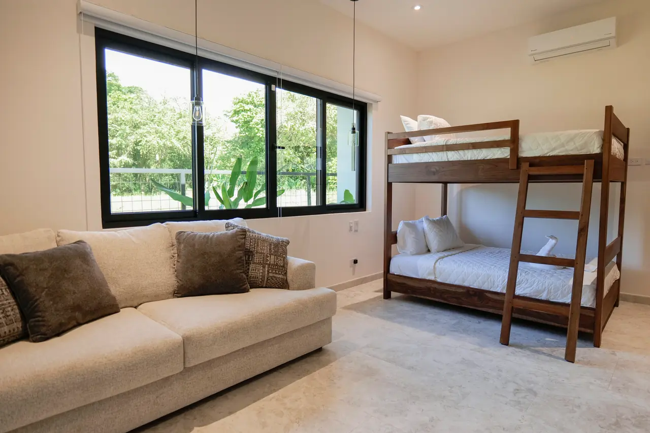 Bunk room — bunk beds and lounge seating with garden outlook