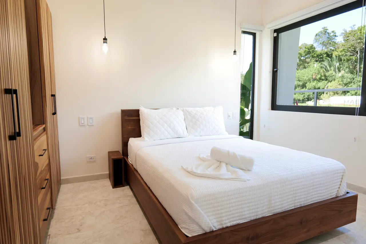 Guest bedroom with hardwood joinery and garden view