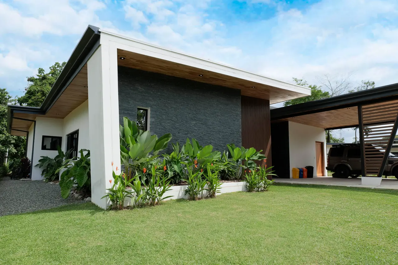 Exterior elevation — stone feature wall and planted beds