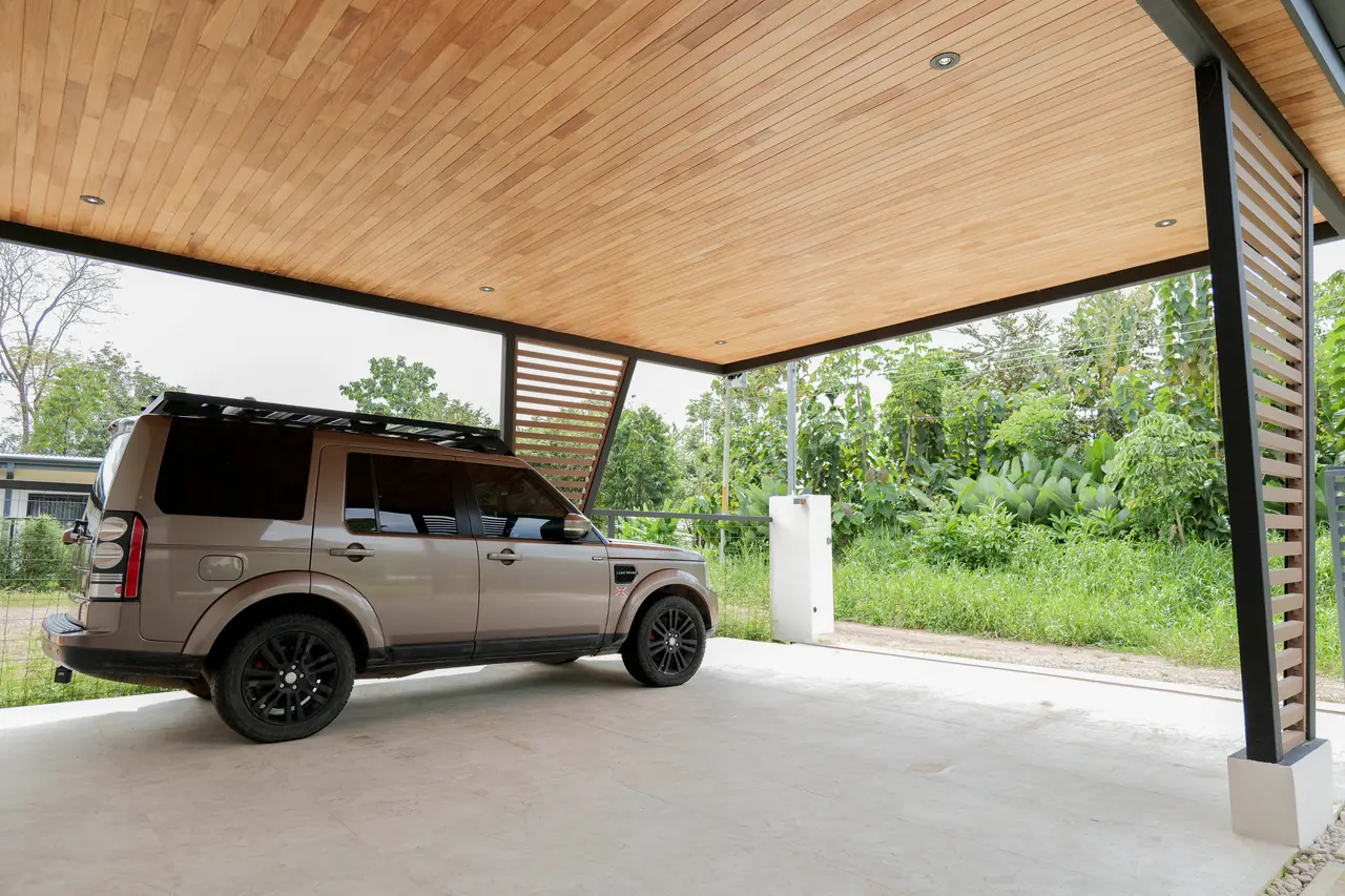 Covered carport under a hardwood-lined ceiling